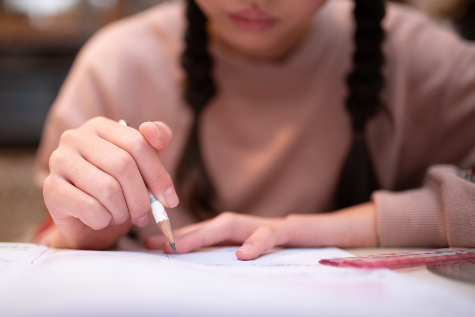 The hands of a child studying